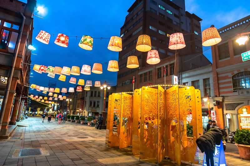 Dihua Street lit up with paper lanterns after sunset.