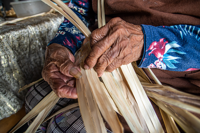 Close up of weaving with moon peach leaves.