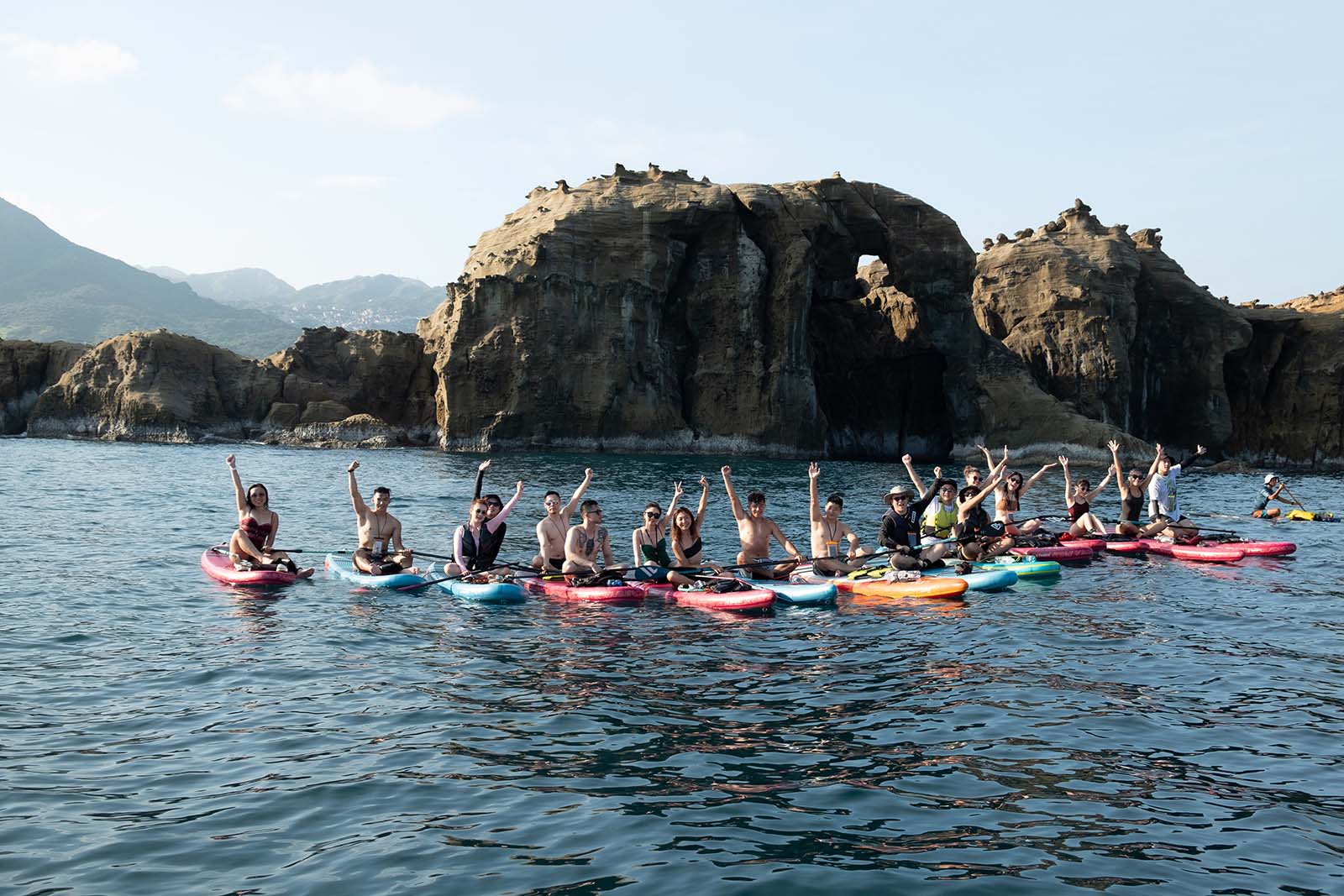 A group of standup paddleboarders in front of Elephant Rock on New Taipei City’s Northern Coast.