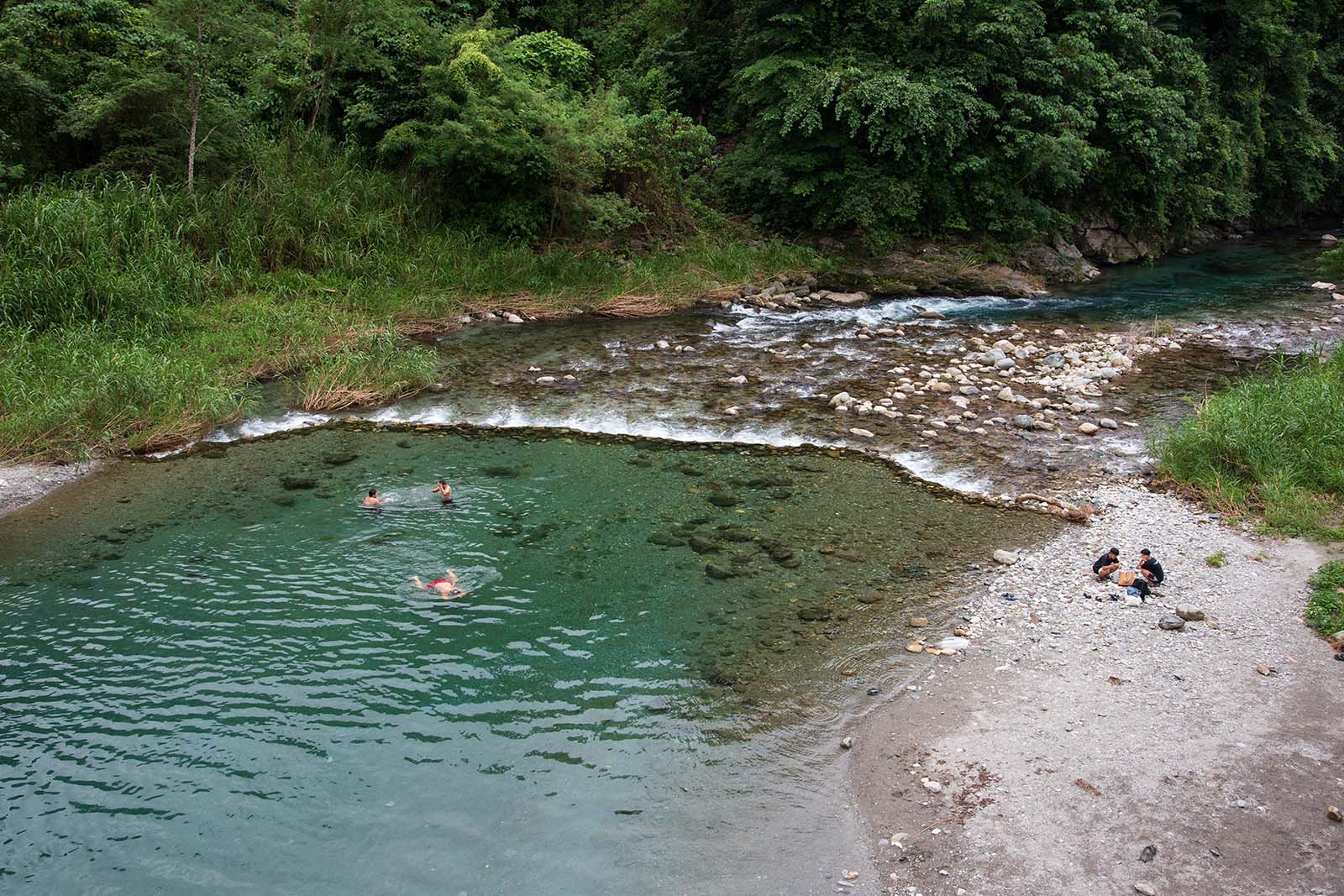 Locals are swimming and playing in Shoufeng's Baibao River.