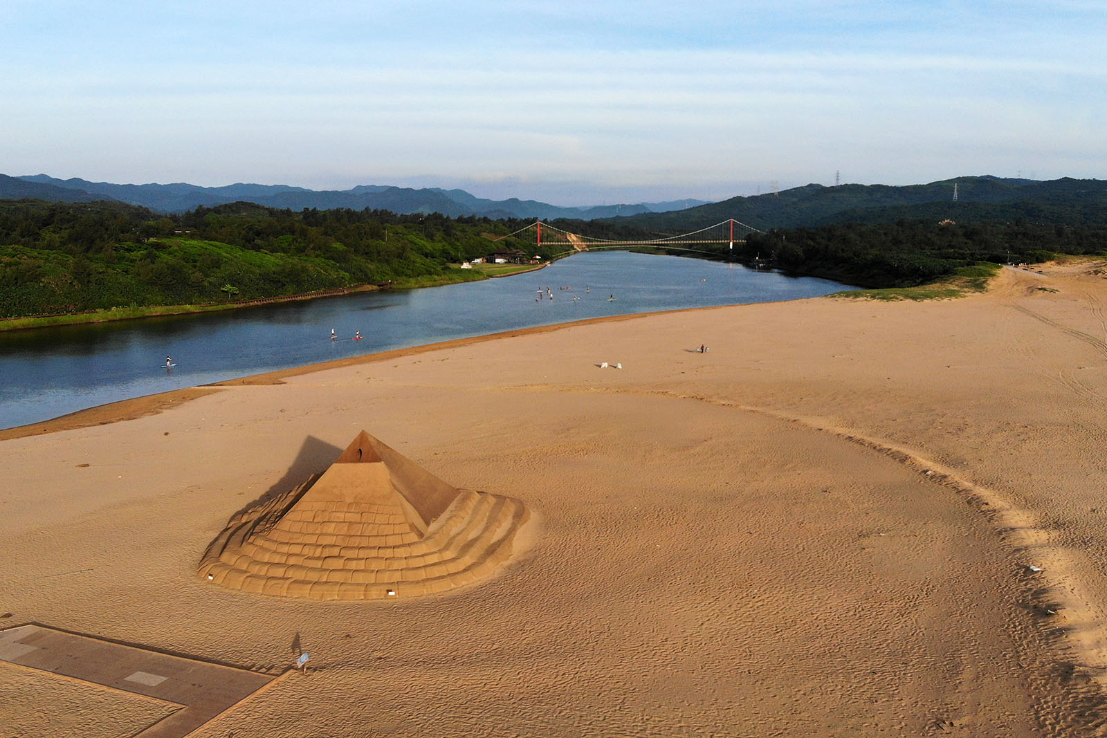 This massive pyramid is part of the sand sculpture festival on Fulong Beach; the estuary of the Shuang River can be seen as well.