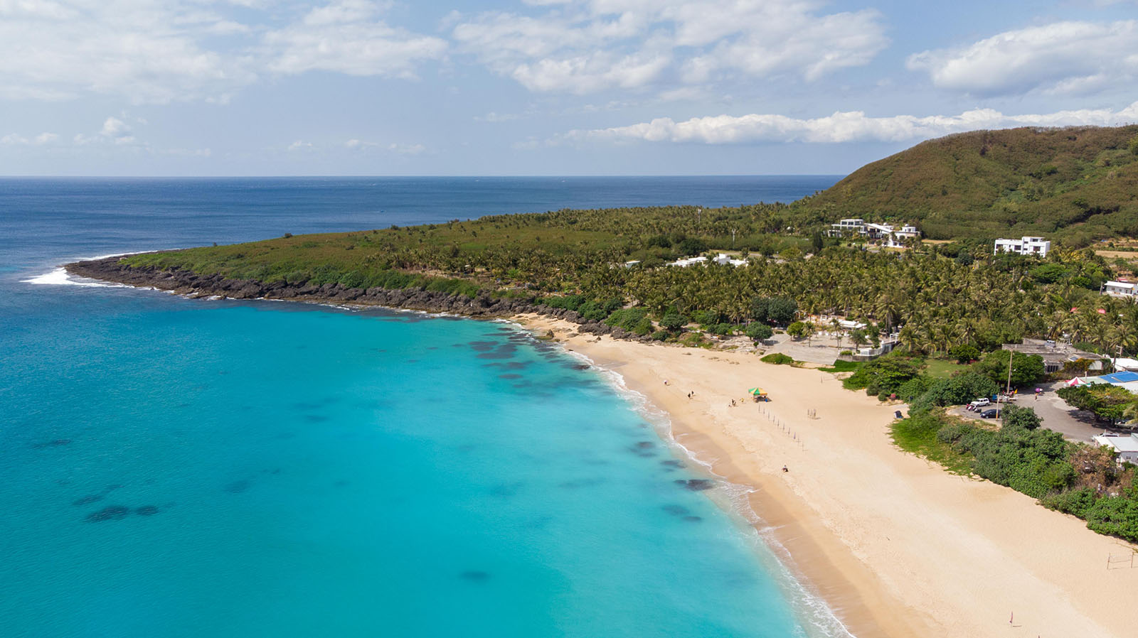 Kenting's most beautiful beach, Baishawan Beach, with beautiful turquoise ocean water, is seen from above.