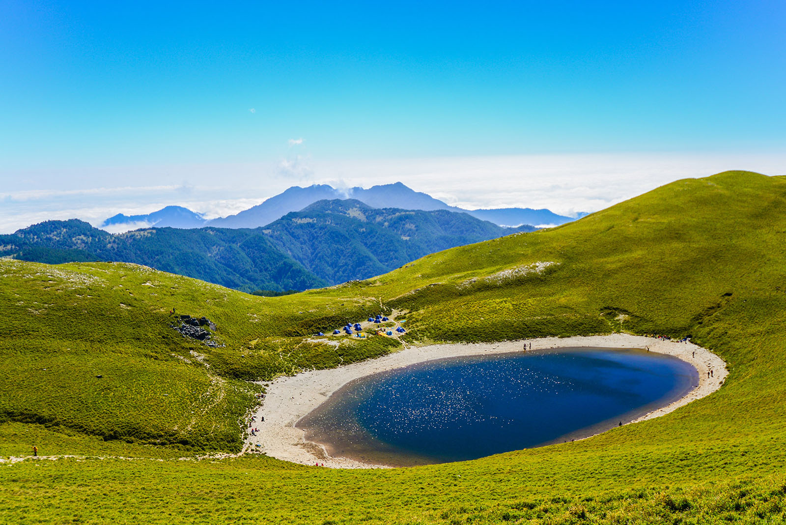 Hikers and tents can be seen at Jiaming Lake on the Jiaming Lake National Trail.