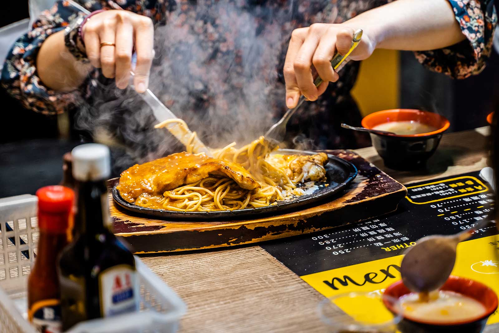 Someone enjoys a sizzling steak.