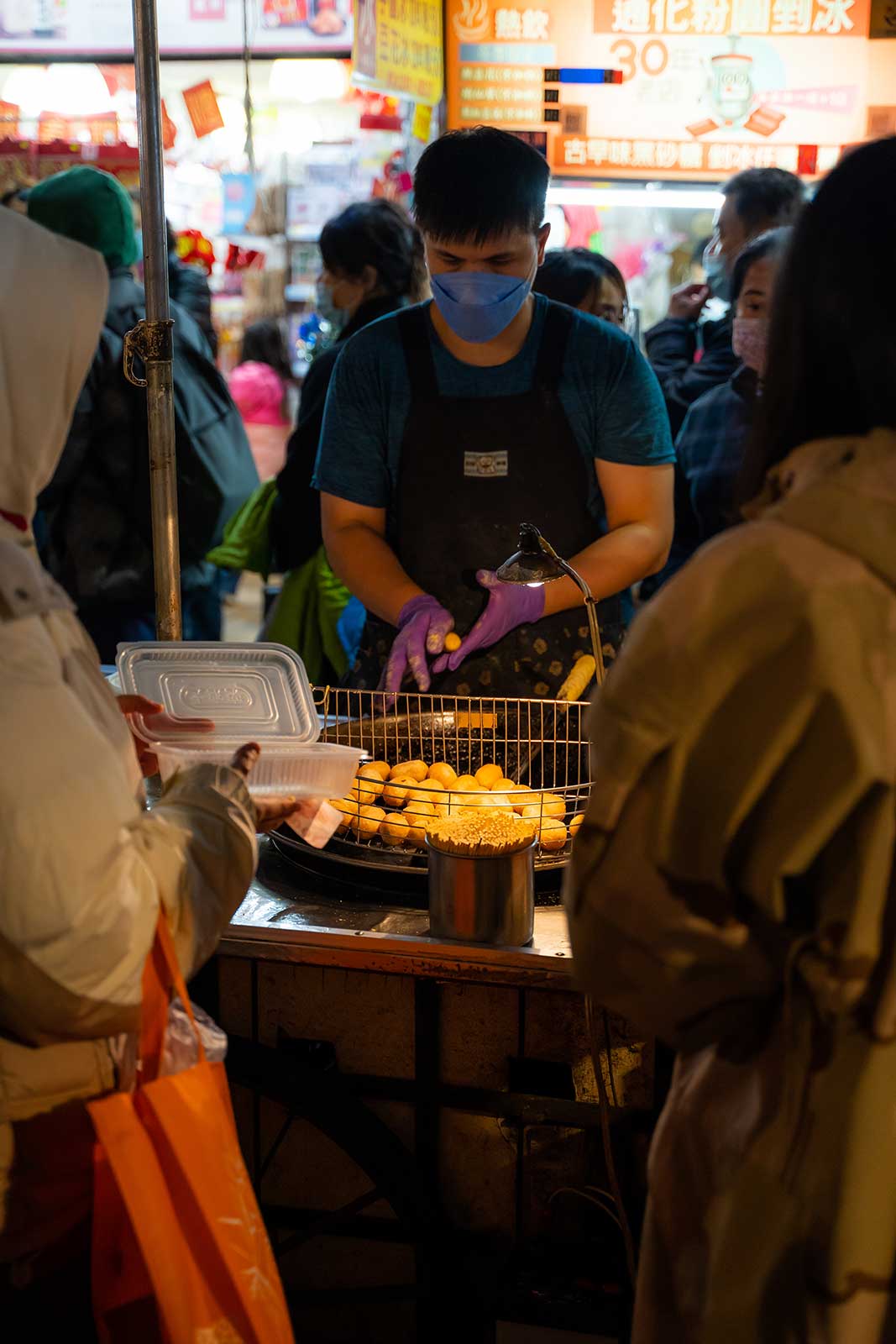 A vender prepares a take out dish.