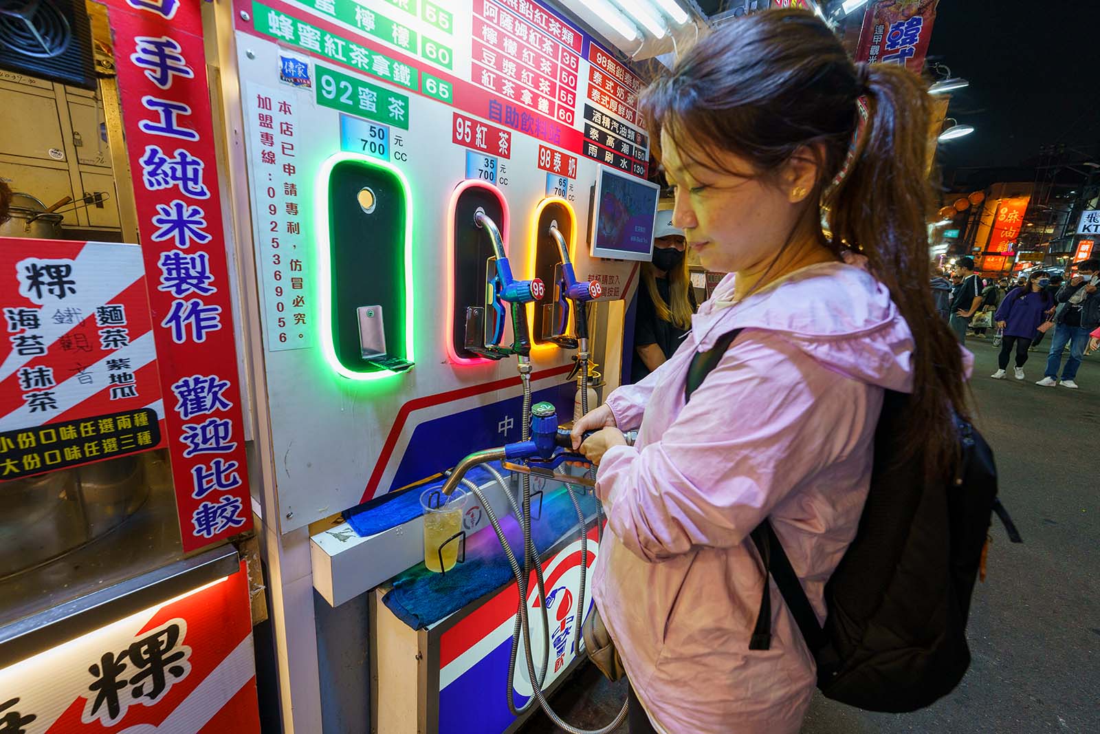 A self-serve tea dispensor in the form of a fuel pump in Feng Chia Night Market.