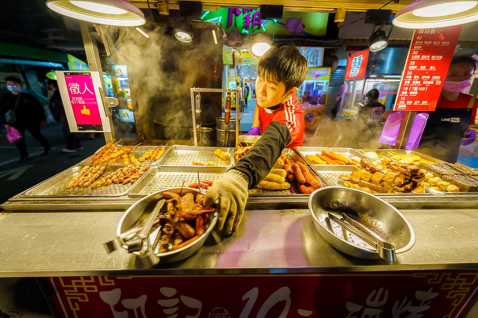 A vendor sells chicken wings and other kebabs.