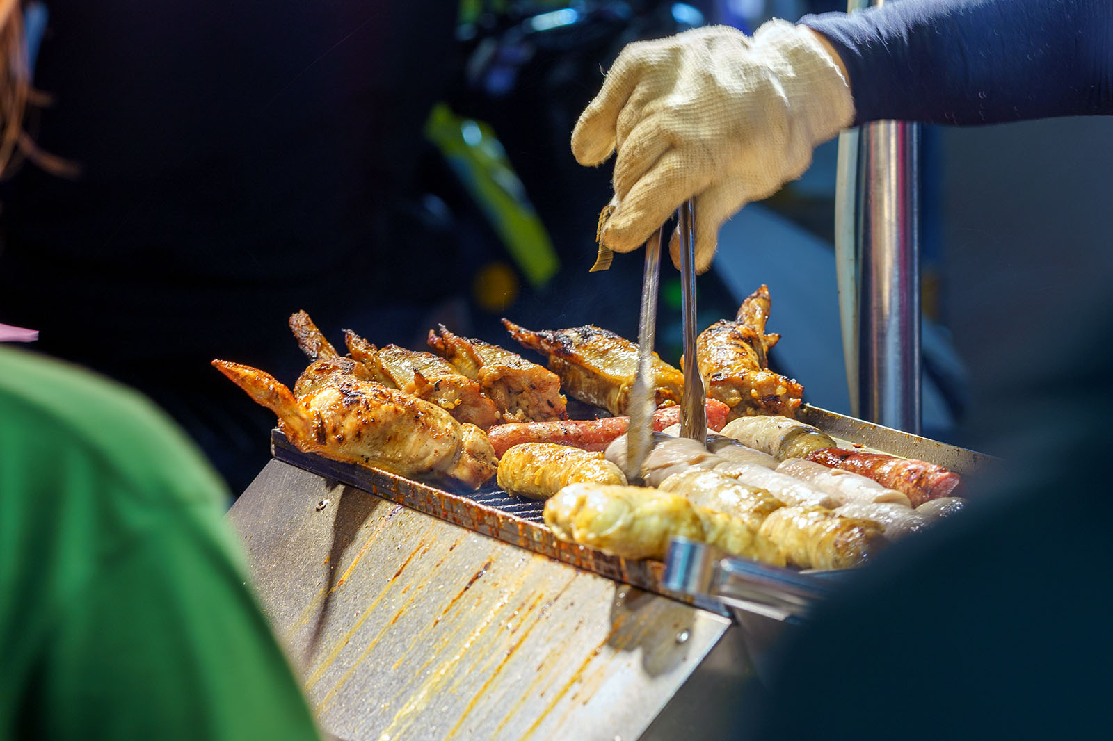 Sausages are being cooked in a night market.