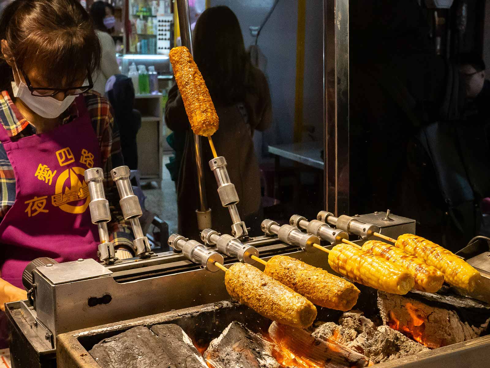 A stall sells roasted sweet corn.