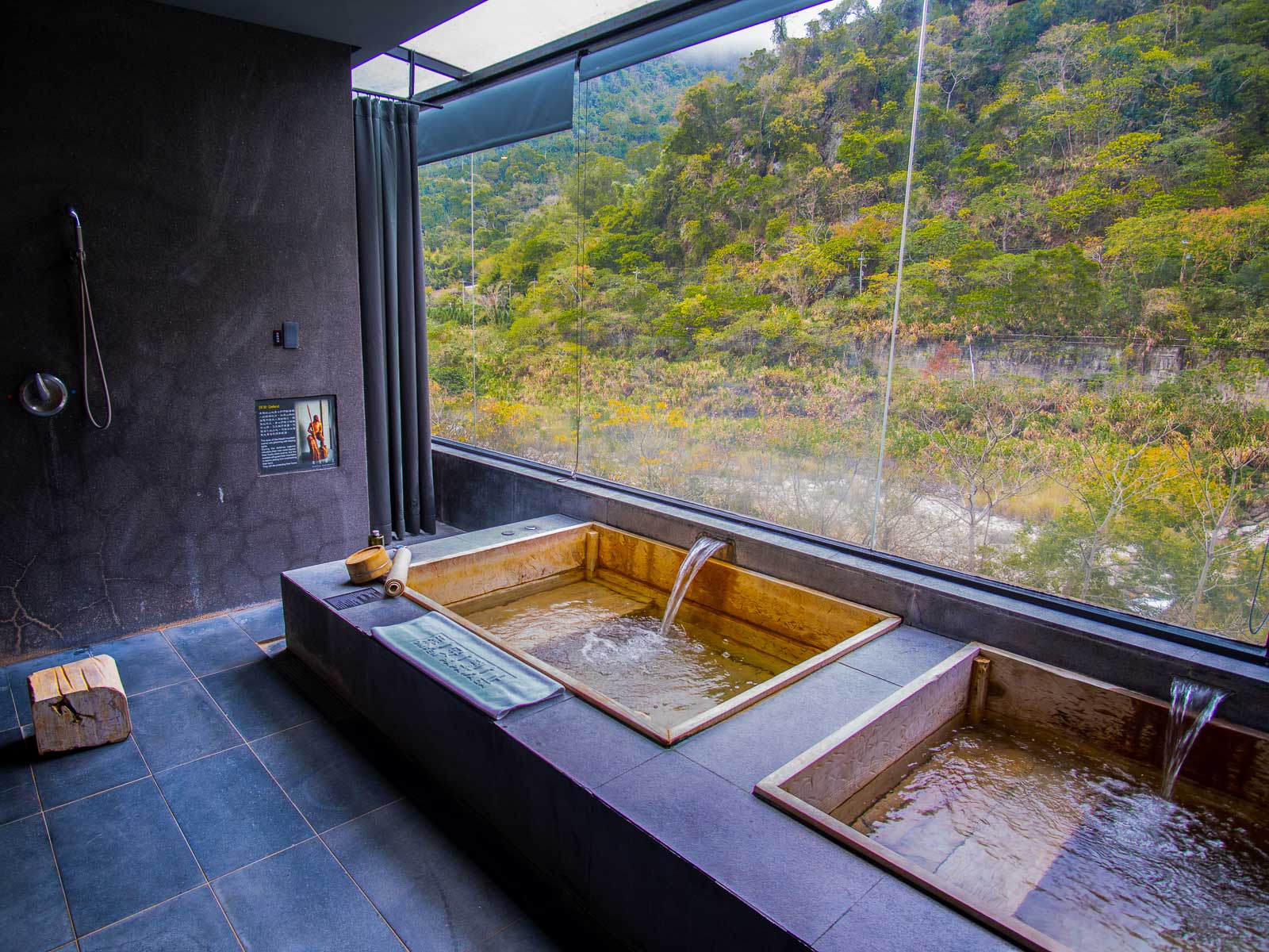 Private indoor bathing pools sit next to floor-to-ceiling windows that overlook the nature outside.