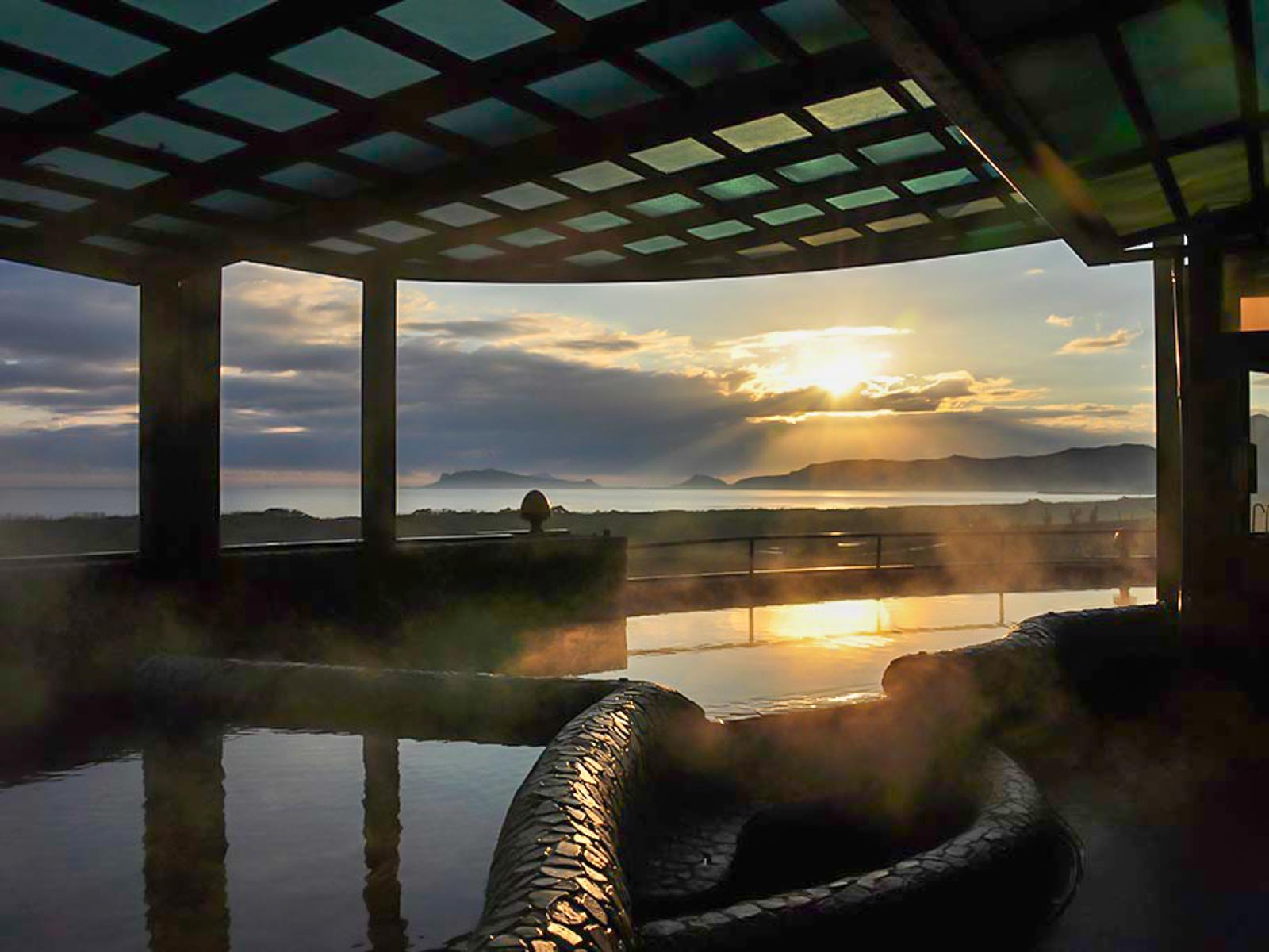 The sun rises over an outdoor hot spring pool in Jinshan.