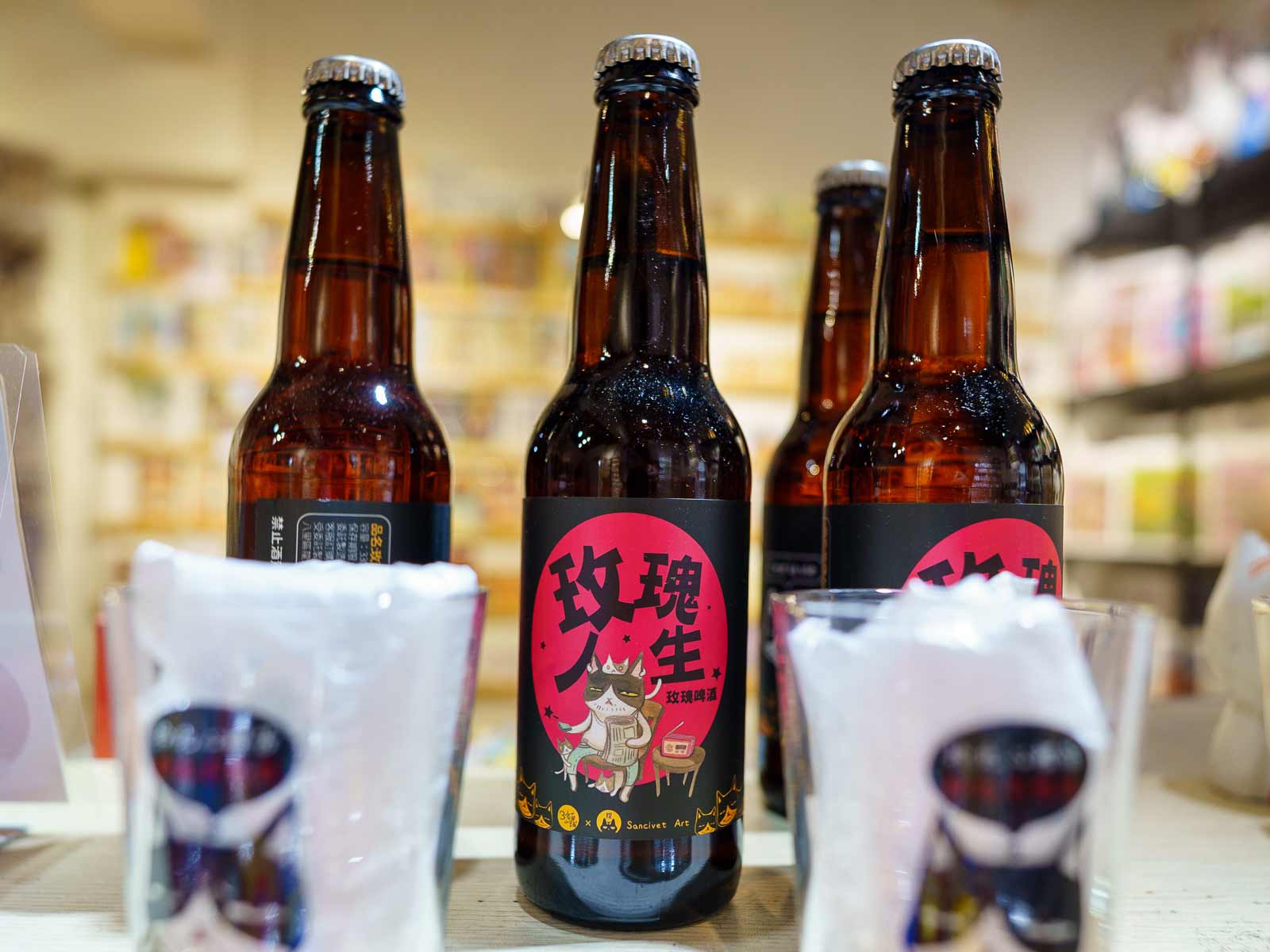 Bottles of cat-themed beer on display in a store in Houtong Cat Village.