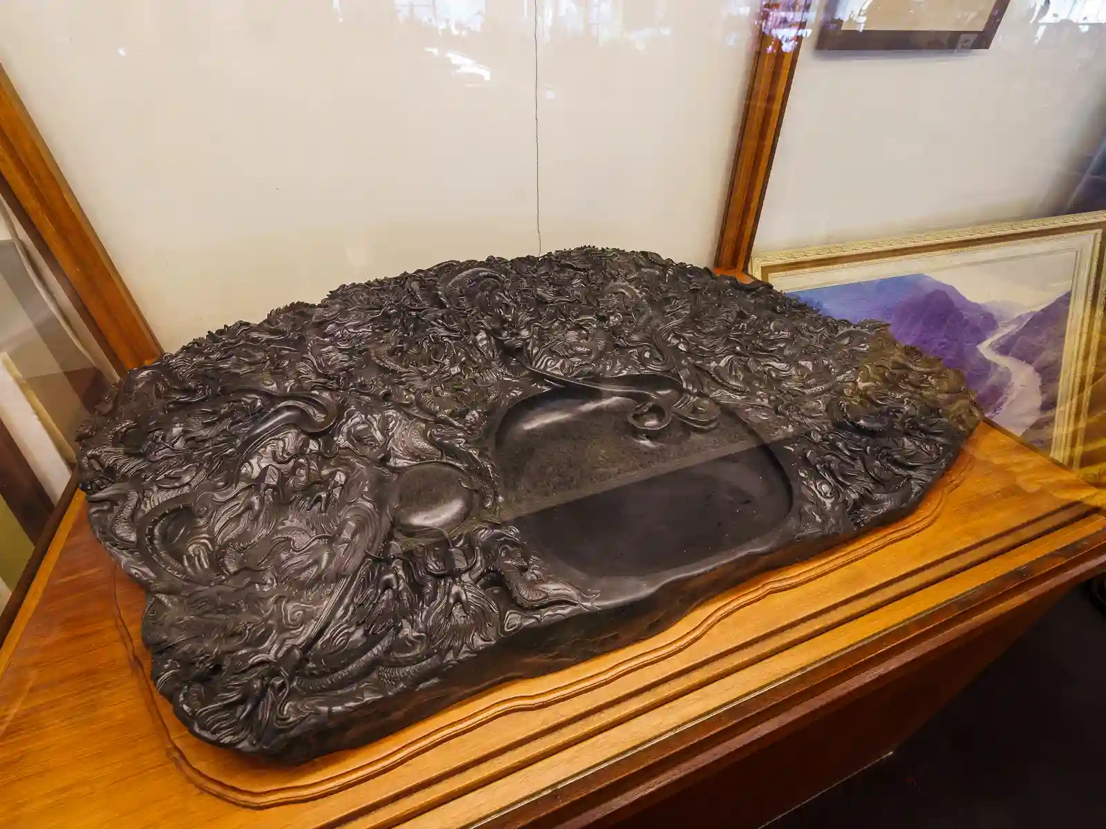 An inkstone with very intricate stone carvings on display.