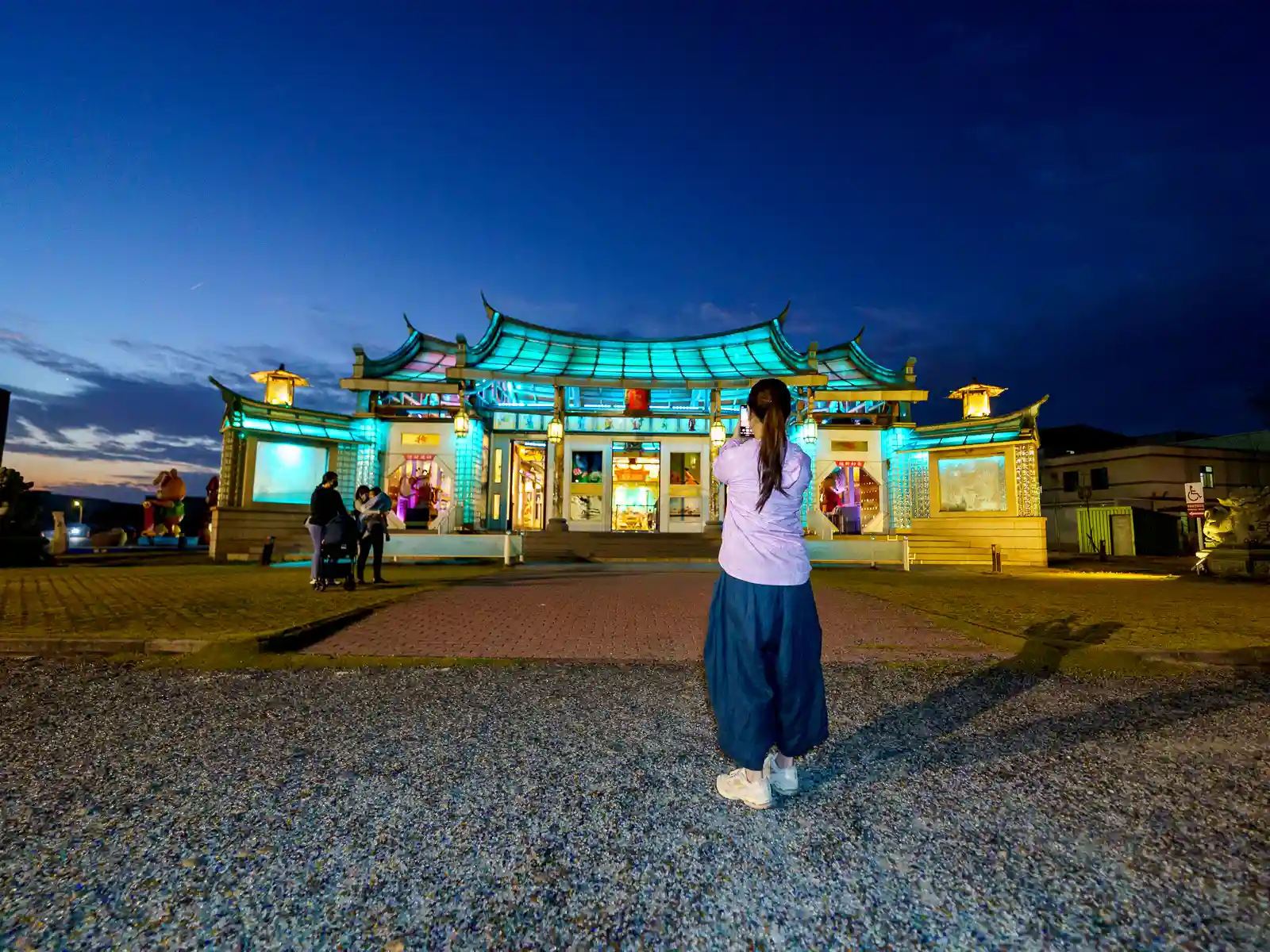 The illuminated Lukang Glass Temple seen from the outside at night.
