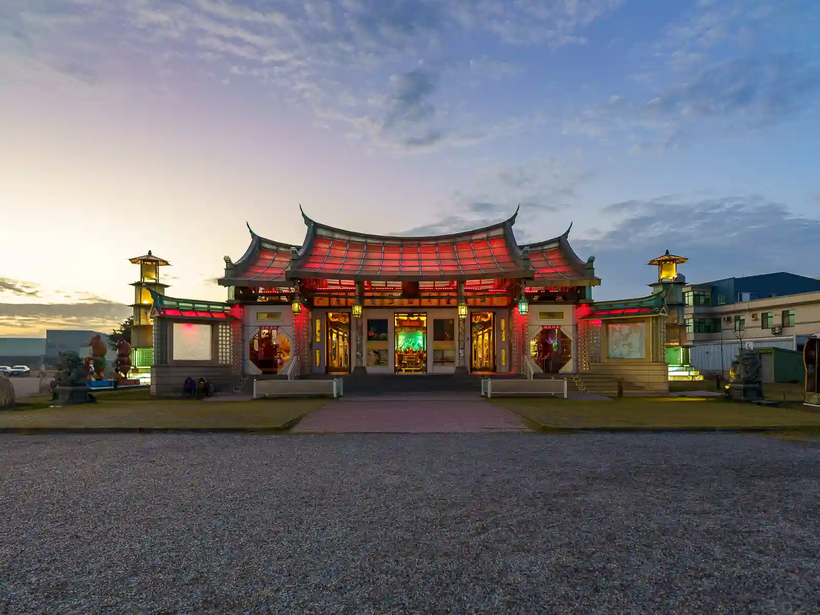 The sun sets over Lukang Glass Temple, which shines red from its own illumination.