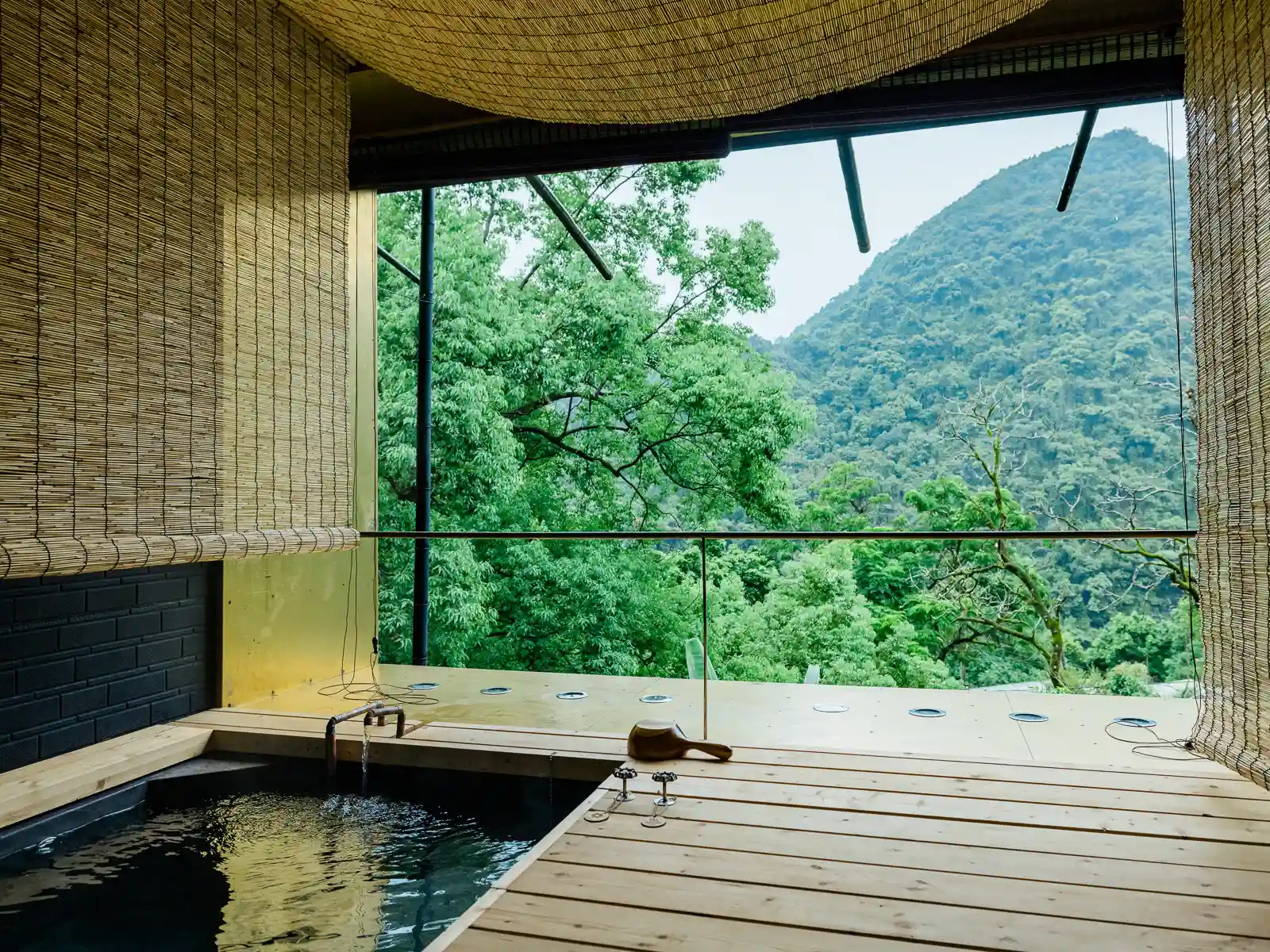 A private bathing area on a balcony looks out over jungle.