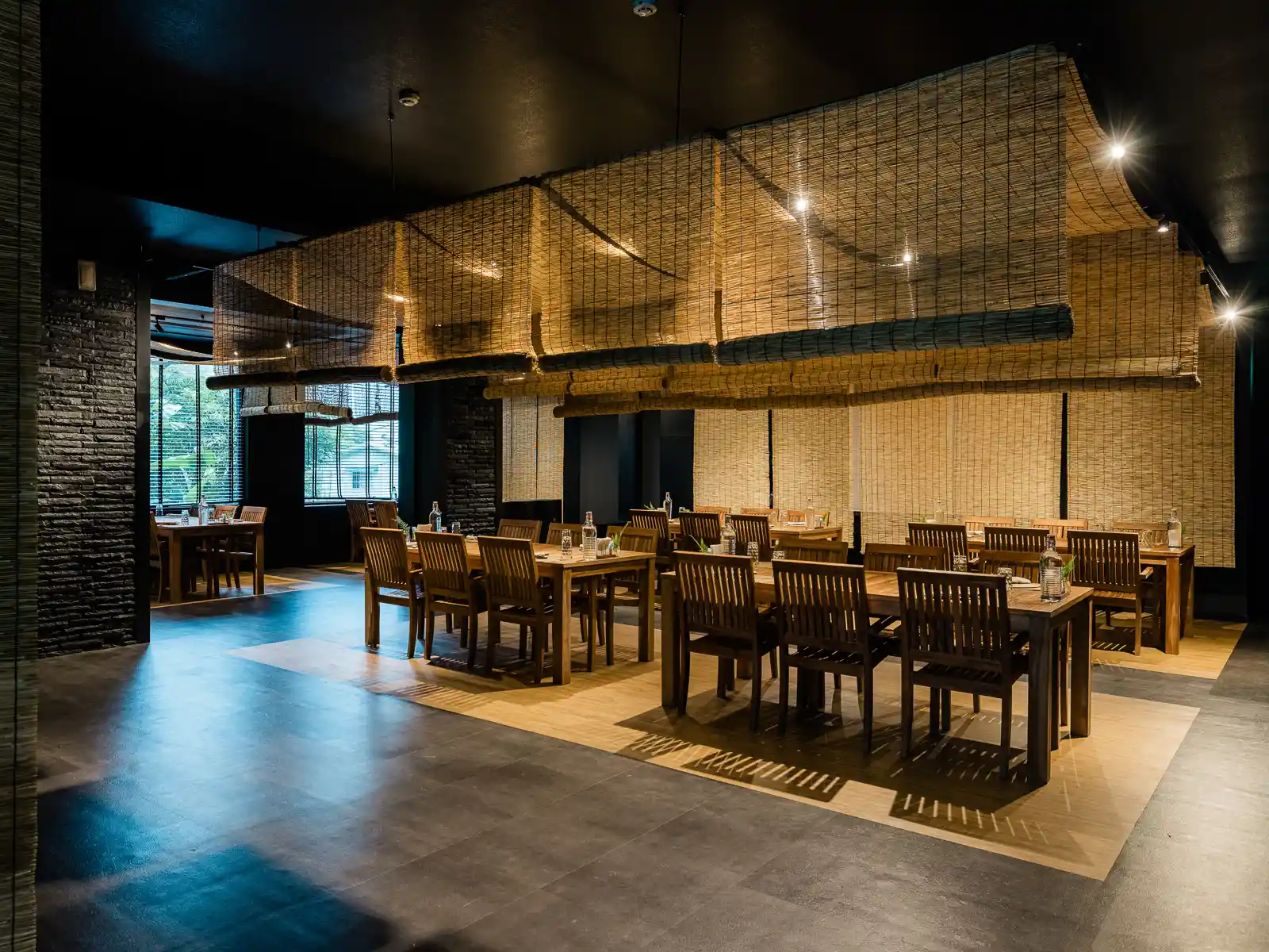 Several tables are set up in a spacious dining area.