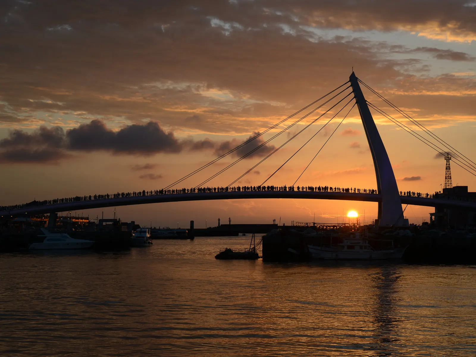 The sun sets with Lover's Bridge in the foreground.
