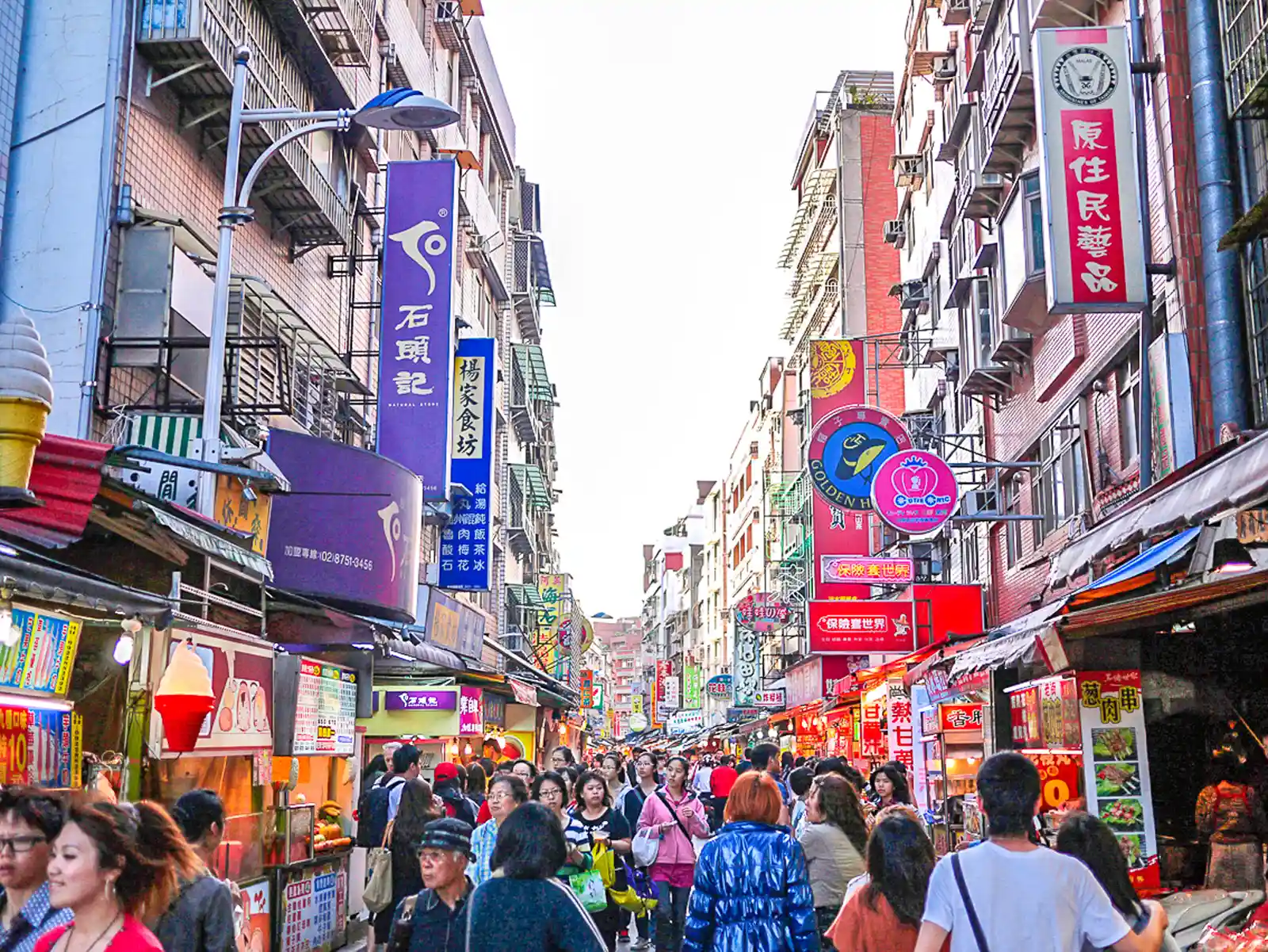 Crowds of people walk through Tamsui's rather modern-looking old street.