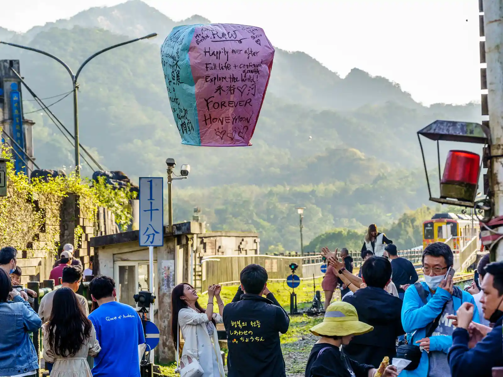 A lantern with several wishes written in English is released into the air.