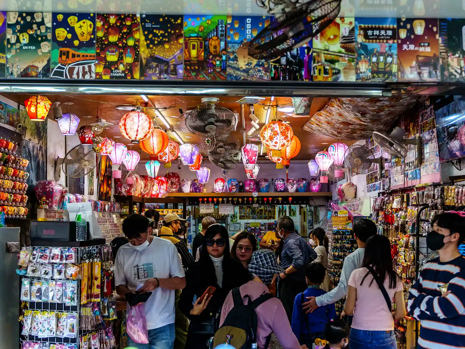 A busy souvenir shop sells lanterns and trinkets.