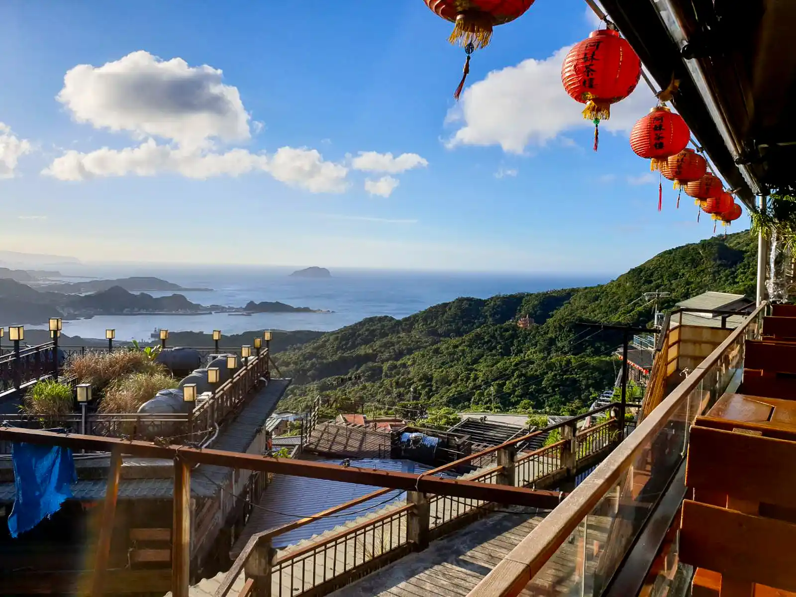 The North Coast extends in the distance as red lanterns hang in the air in this view from the Amei Tea House balcony.