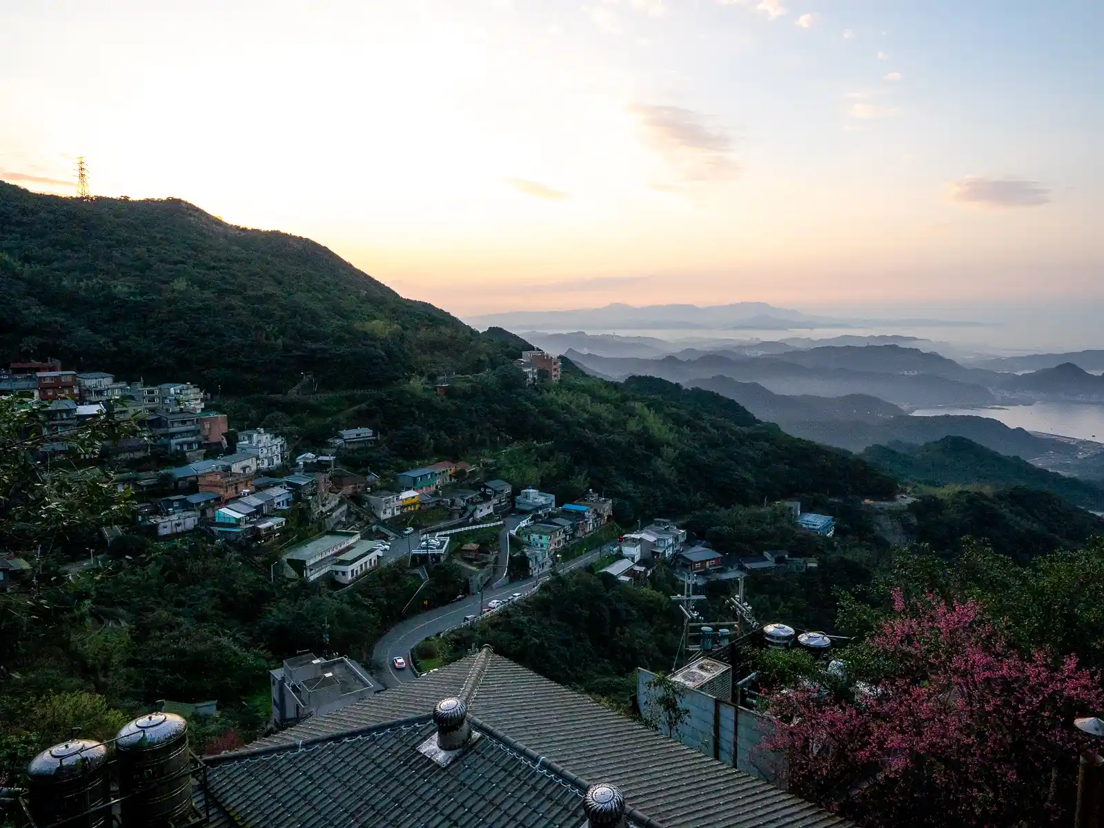 A layer of fog rolls in from the ocean beneath Jiufen.