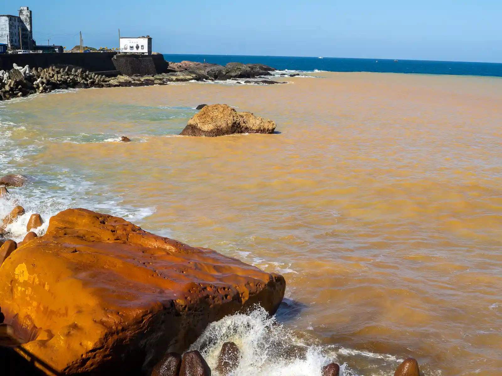 The yellow-brown water of the Yinyang Sea stretches out for 100 yards until it mixes with ocean water.