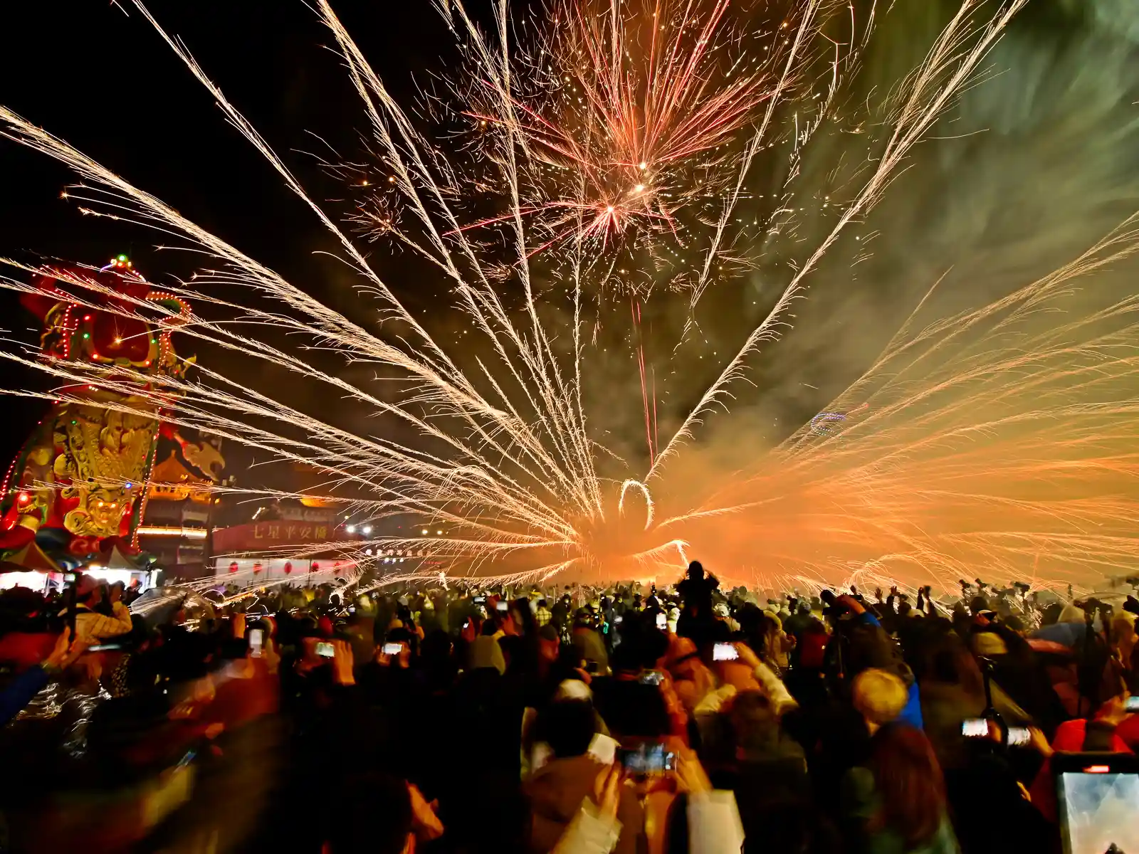 Firecrackers shoot in every direction including at the crowd in a beehive-style display.