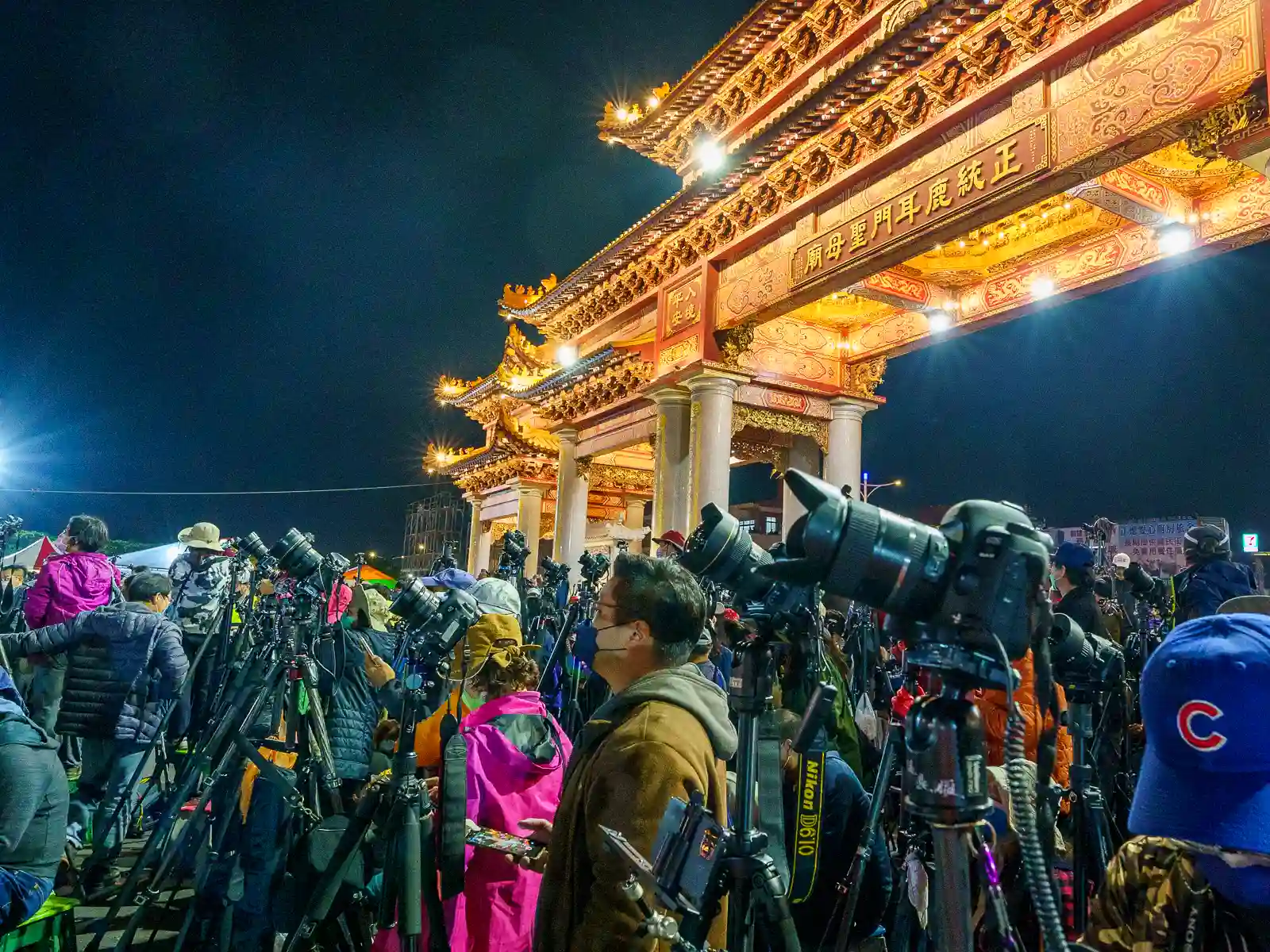 Hundreds of photographers with tripods set up await the beginning of the fireworks show.