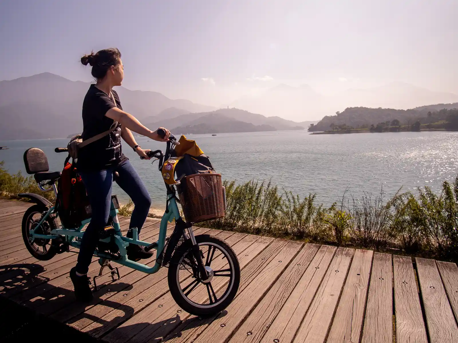 A tourist rides a rental bicycle on the Xiangshan Section of the Sun Moon Lake Bikeway.