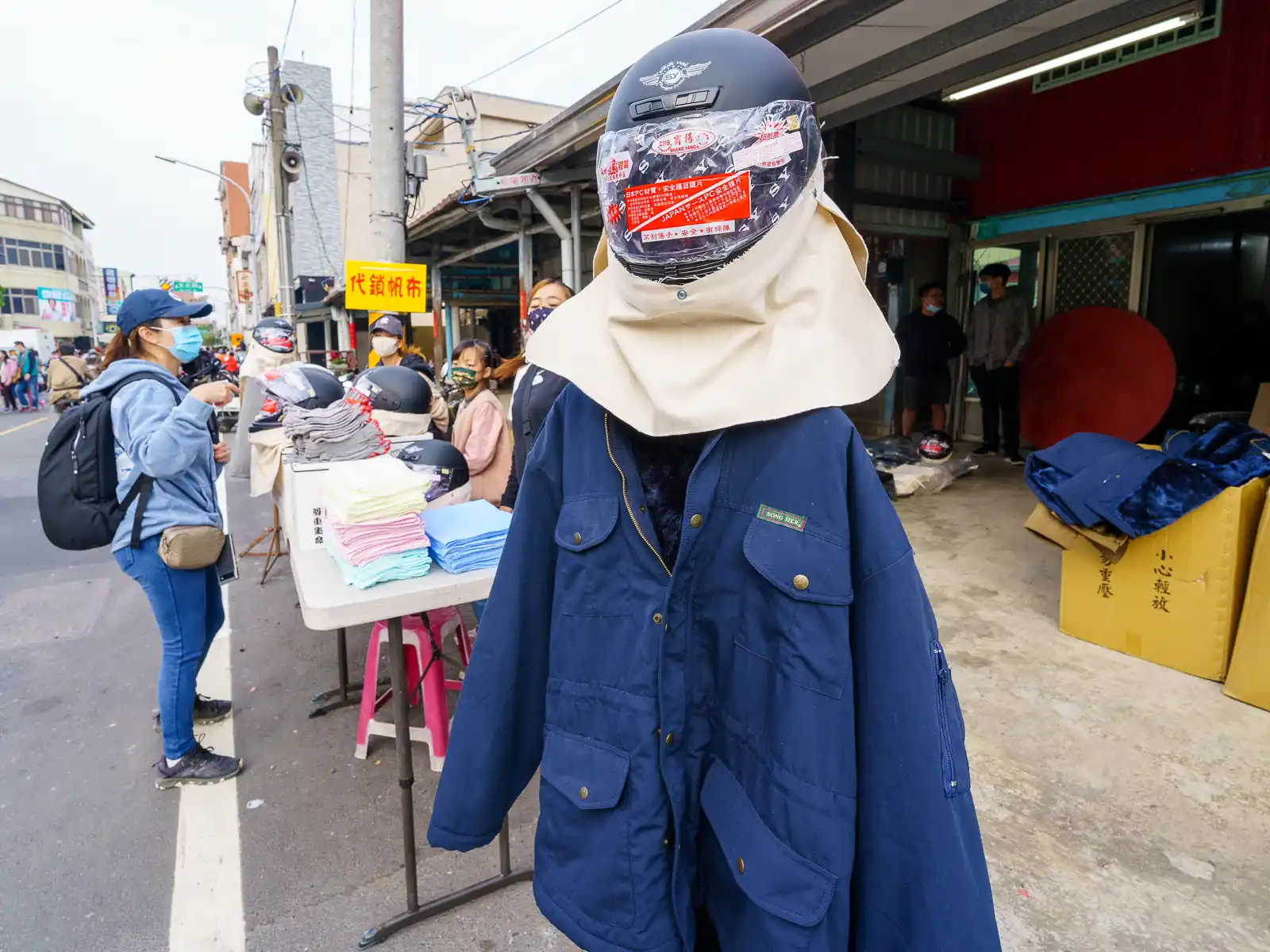 Thick jackets, neck protectors, and motorcycles helmets that are meant to be worn as protection are on sale in Yanshui just before the event.