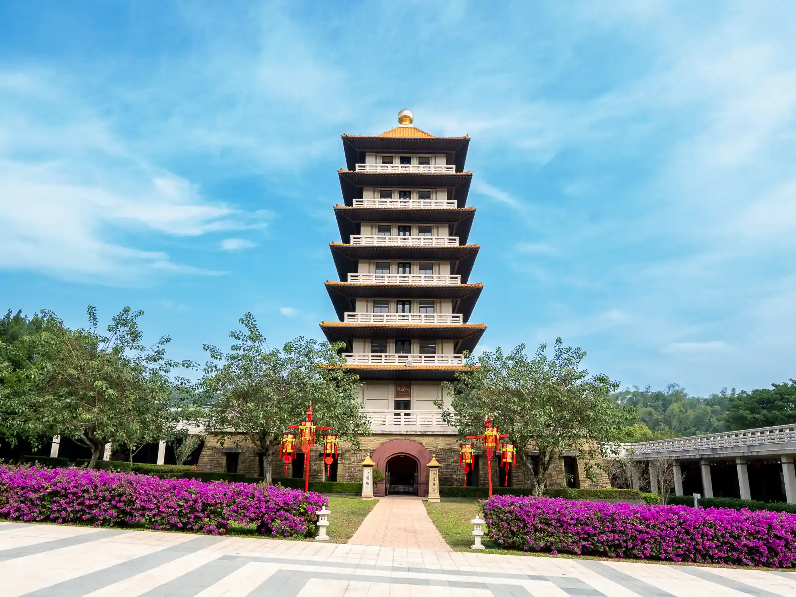 An eight story pagoda with a golden roof.