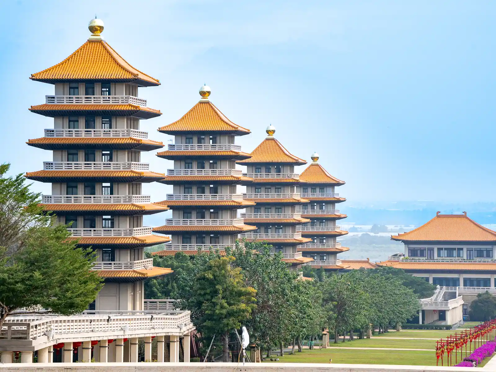 A view from the main hall of one side of the courtyard featuring four pagodas.