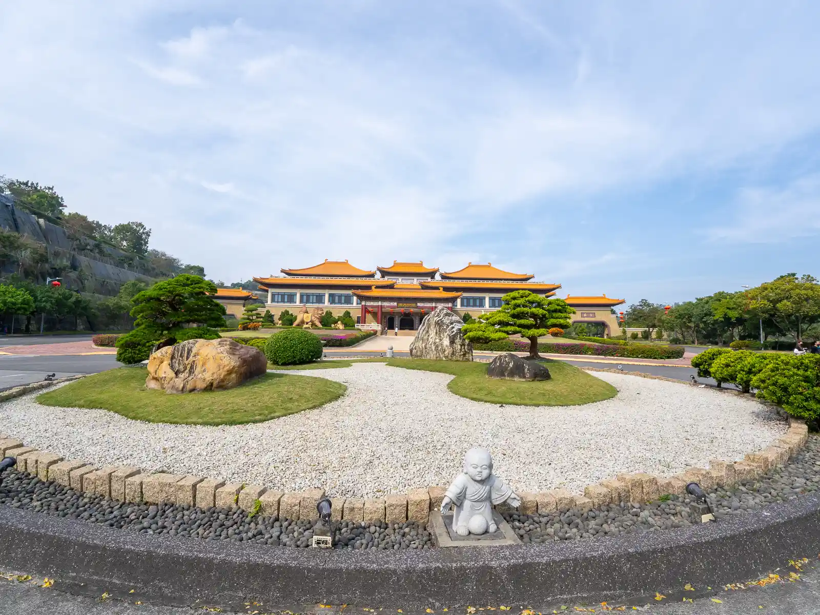 The Front Hall of the museum is visible behind carefully maintained gardens.