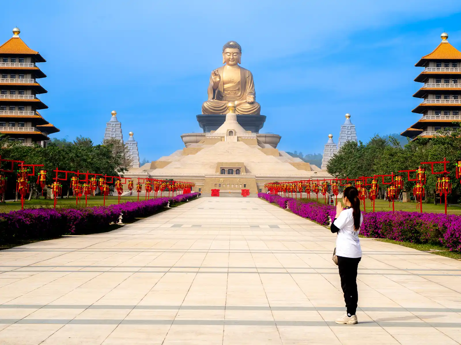 One tourist stands for a photo in front of the path to the Main Hall and Fo Guang Big Buddha.