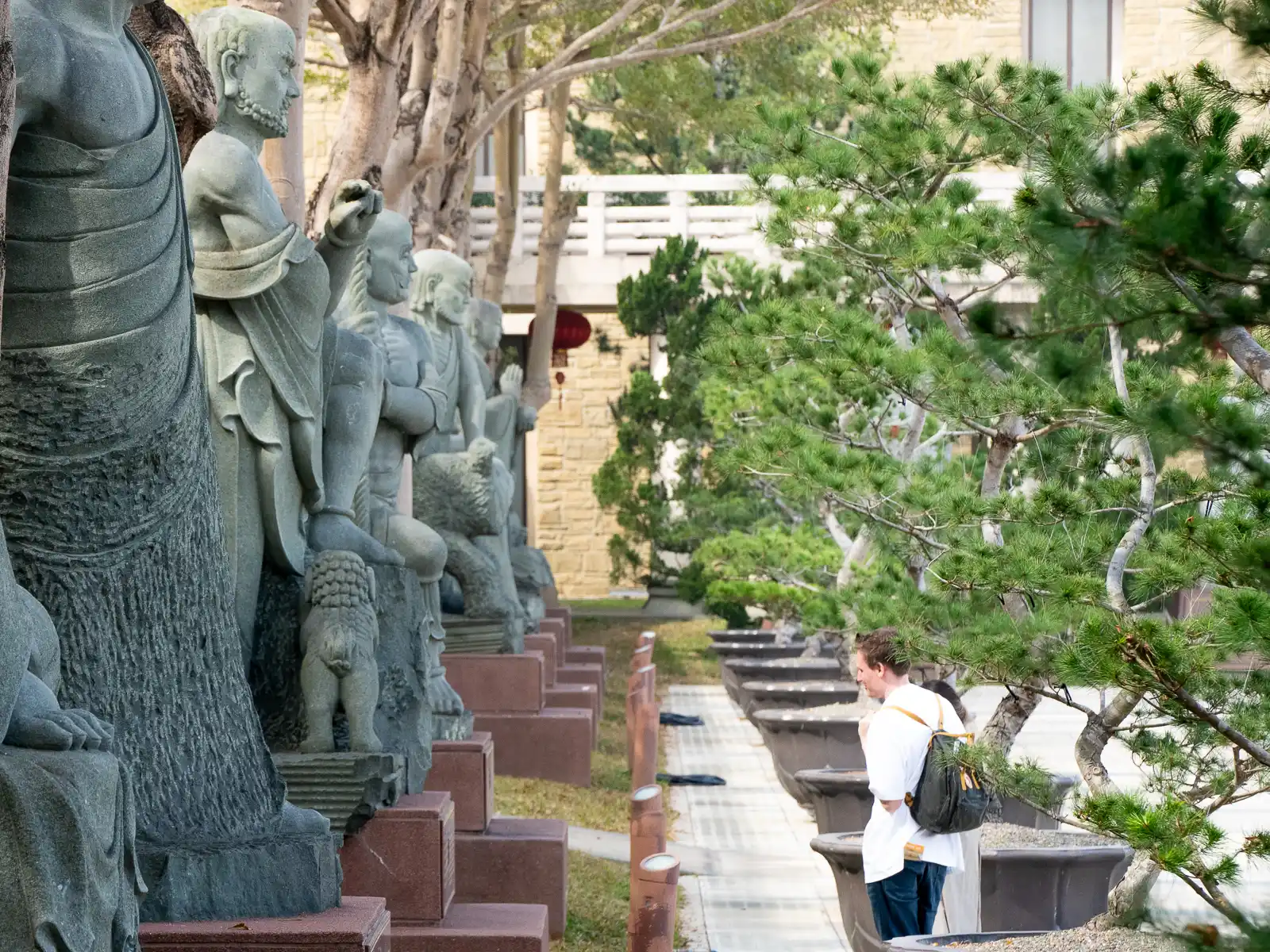 Stone statues representing the Eighteen Arhats line the sides of the Grand Photo Terrace.