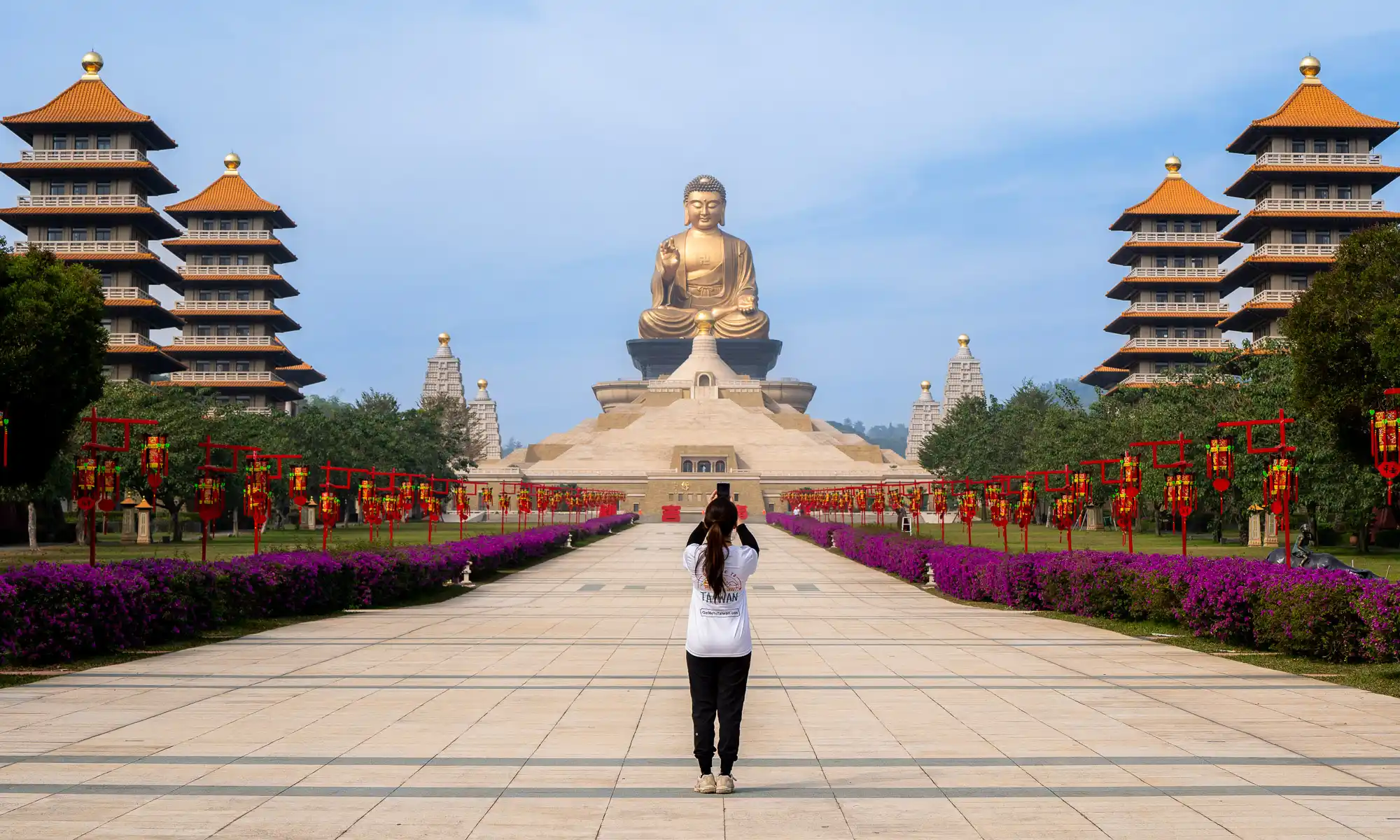 A tourist takes a photo in the courtyard of the Fo Guang Shan Buddha Museum.