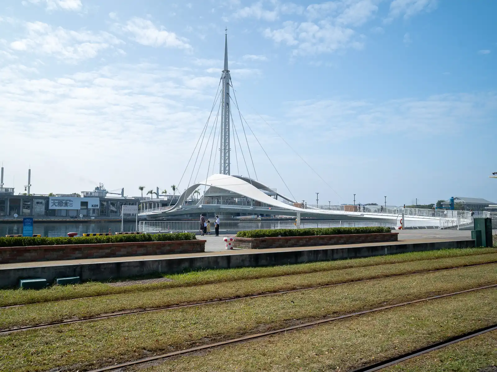 The Great Harbor Bridge which features a tall central spire connects piers along both sides of the harbor.