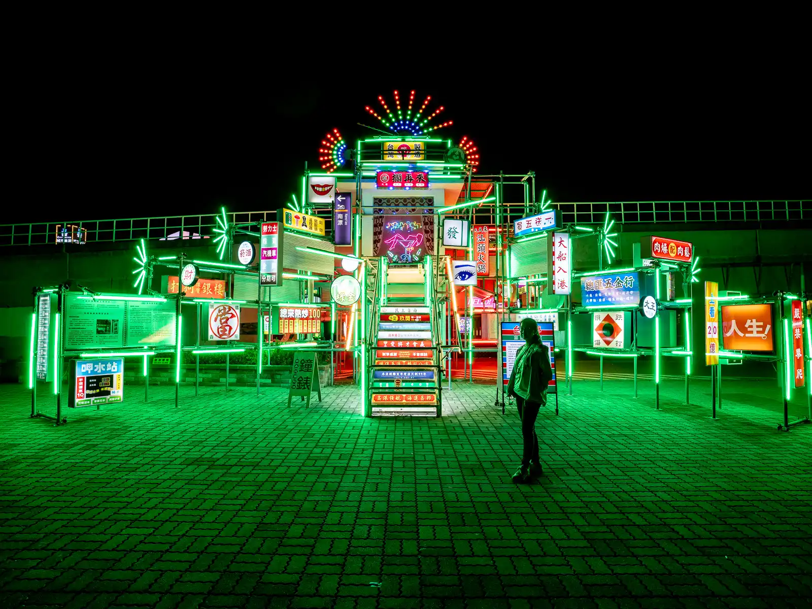 A piece of installation art is composed of dozens of neon signs and neon lights build into a giant structure.