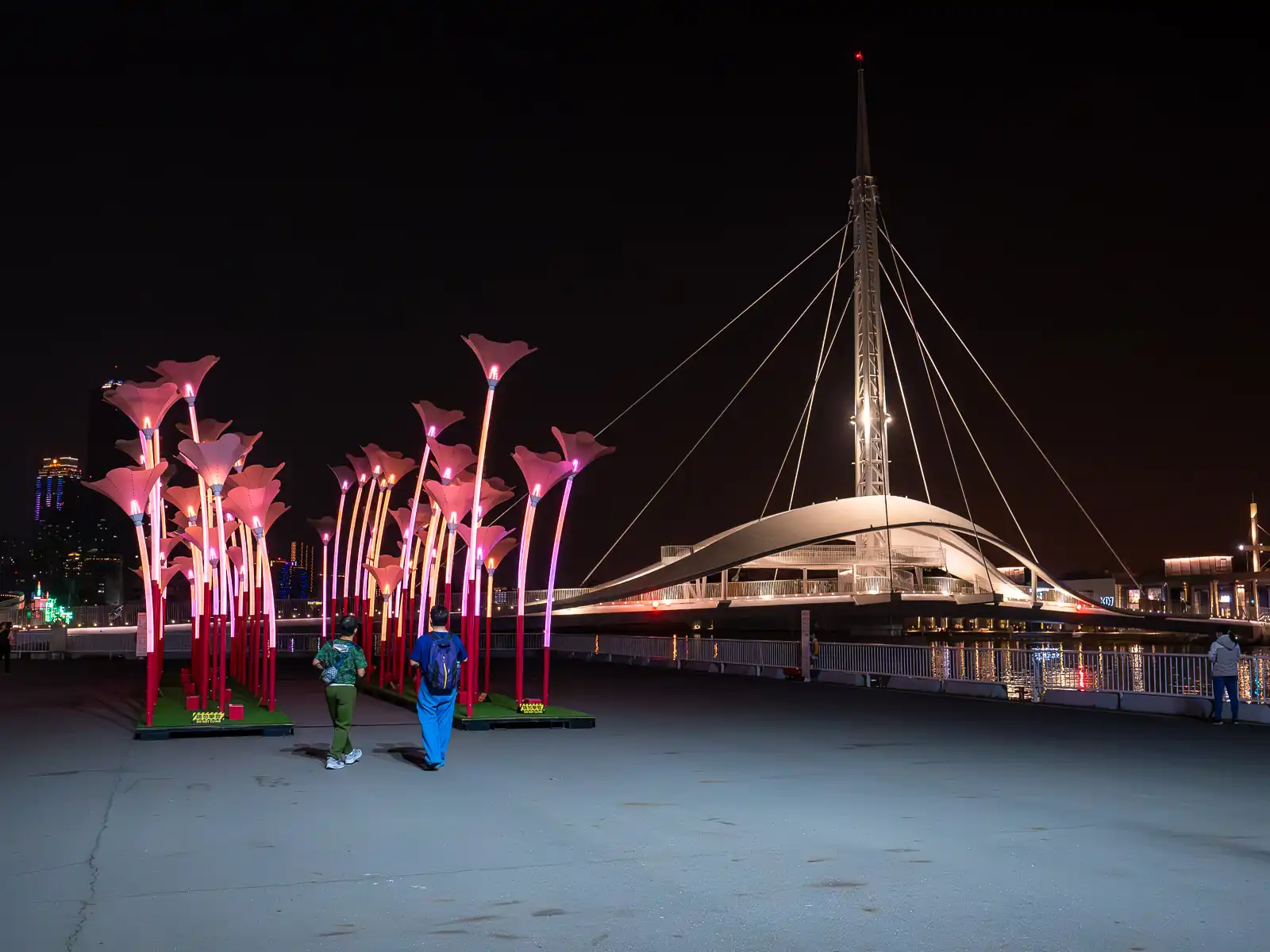 Gigantic glowing flower-shaped lamps decorate the boardwalk outside of Pier 2 Art Center.