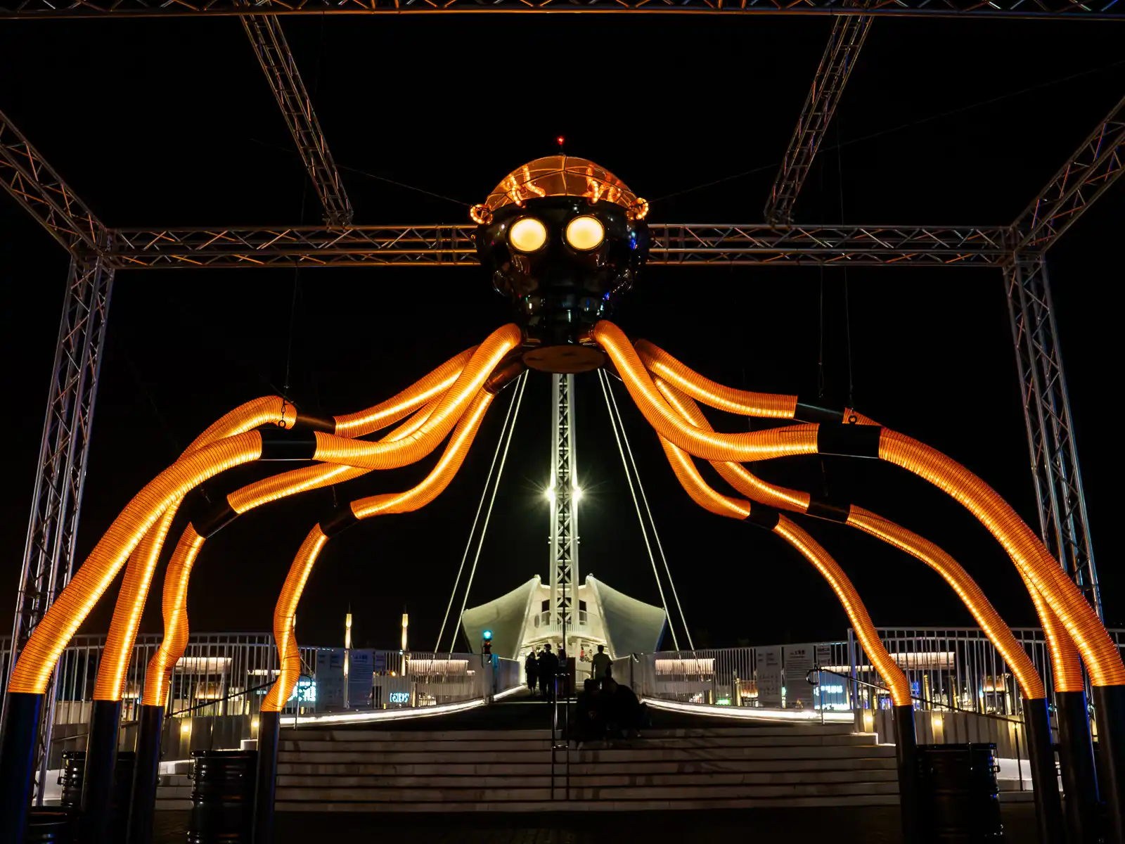 A glowing octopus like sculpture stands two stories tall.