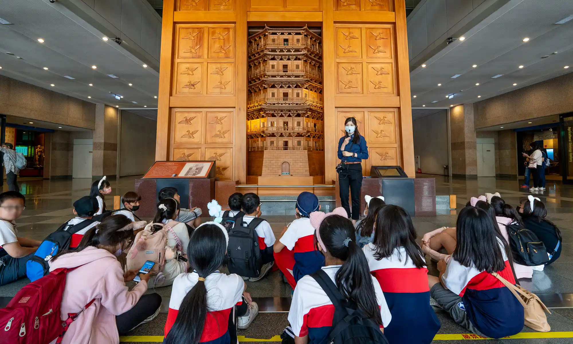 A group of students listens as an exhibit is introduced in the National Museum of Natural Science in Taichung.