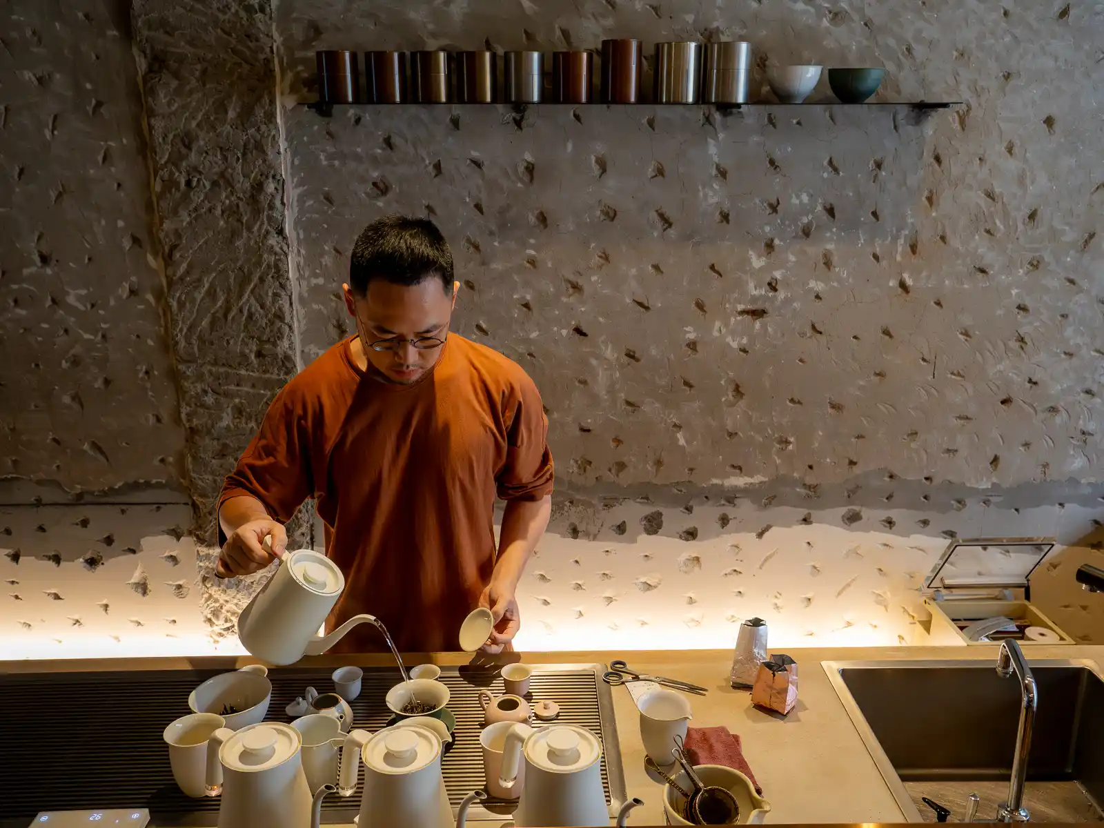 Zhao Zhao Tea Lounge owner Chen Zhongyun brews a pot of tea behind the first floor bar.