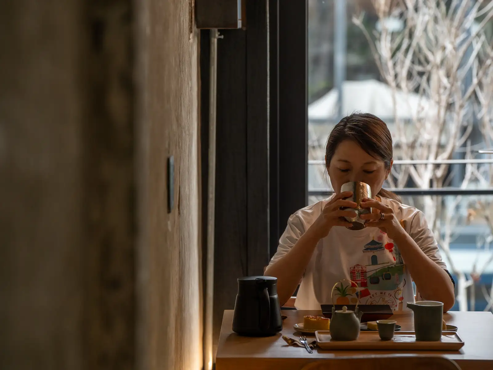 A guest peacefully enjoys a cup of tea on the second floor of Zhao Zhao Tea Lounge.