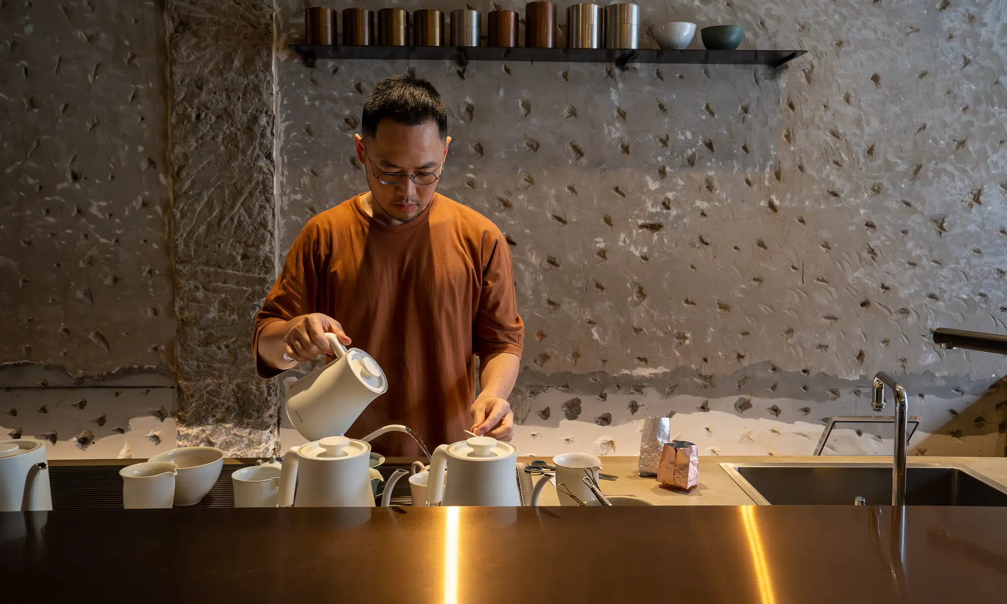 Zhao Zhao Tea Lounge owner Chen Zhongyun brews a pot of tea behind the first floor bar.