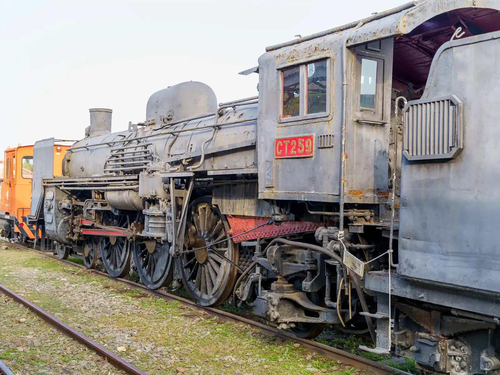 A side shot of a beautiful steam locomotive on display.