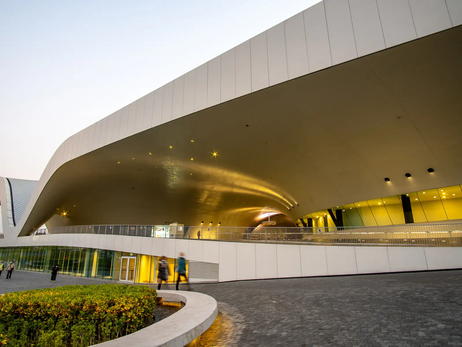 The center's iconic flowing canopy can be seen dipping down at the buildings side.