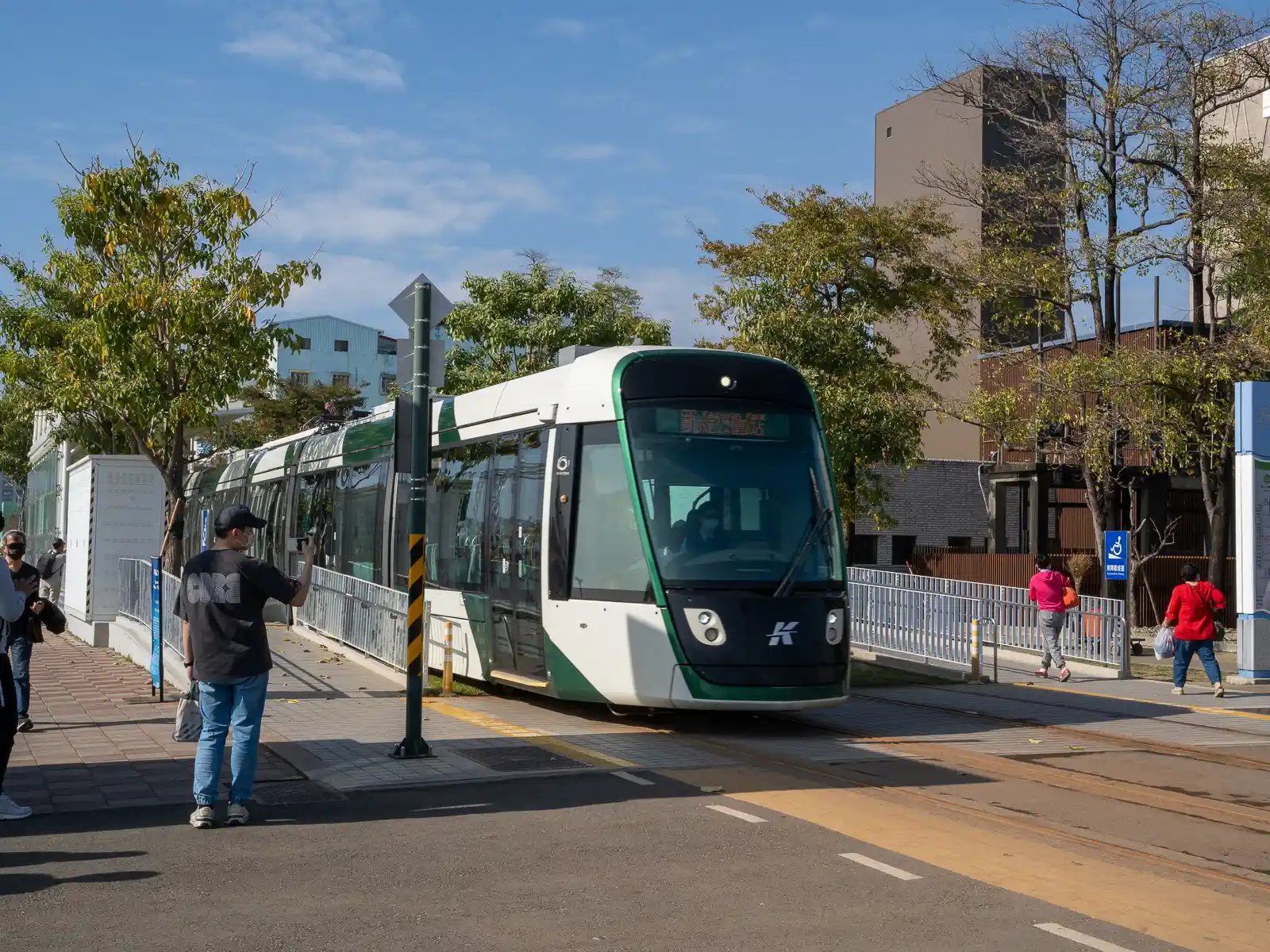 A Light Rail carriage is stopped at a station waiting for passengers to board.