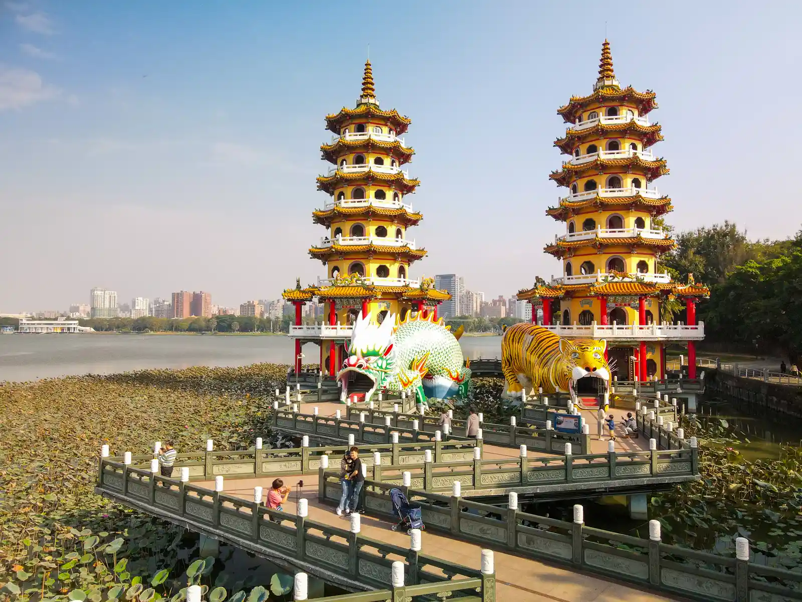 Two 7-story spires built over water are surrounded by lotuses on Lotus Pond.
